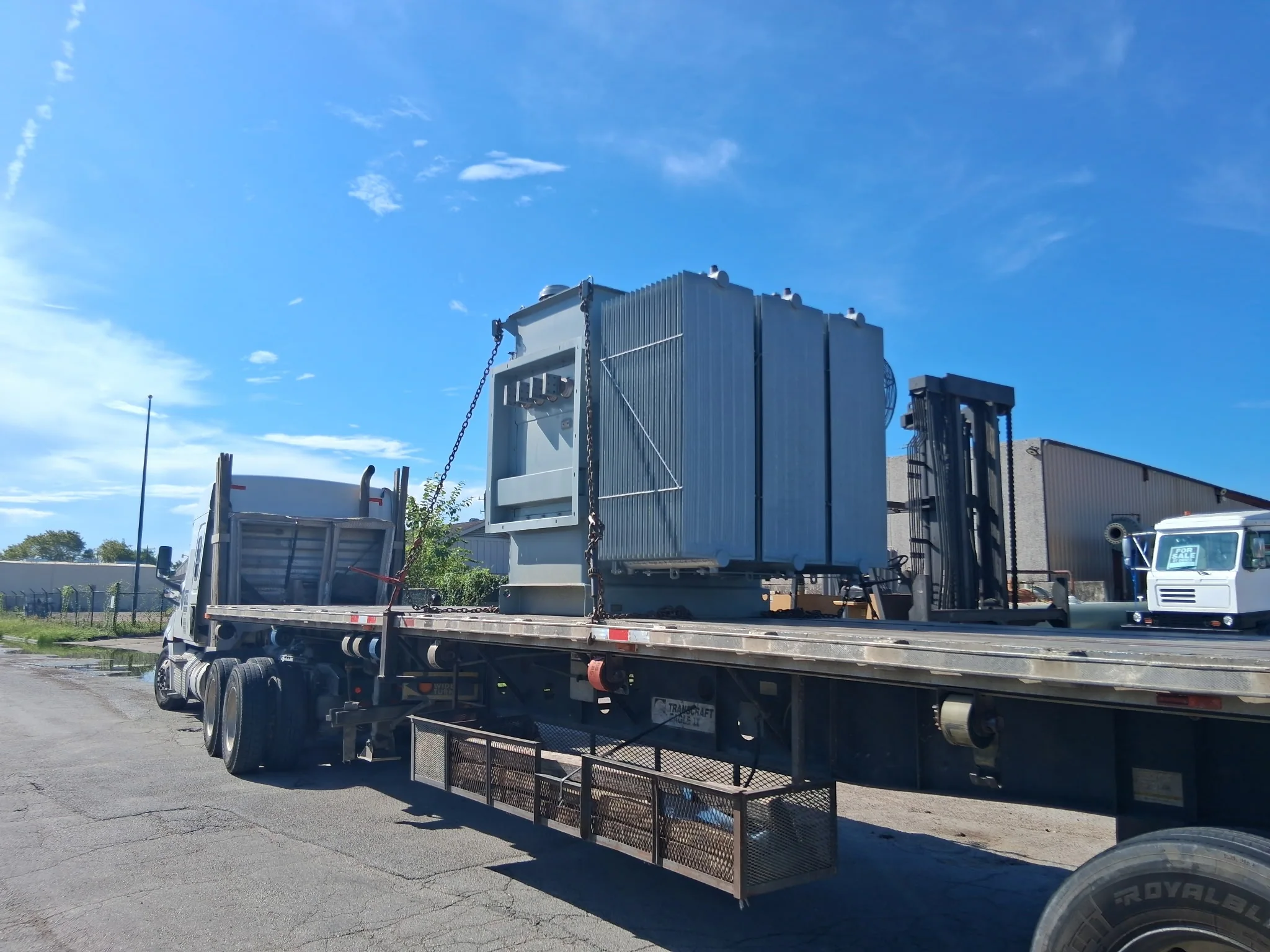 Large transformer loaded on a flatbed truck for transportation